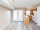 Eat-in kitchen featuring updated appliances, access to living room and patio, and custom cabinetry at 4816 Blue Bird Ct # B, Raleigh, NC 27606