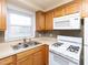 Charming kitchen showcasing stainless steel sink, and gas range at 4816 Blue Bird Ct # B, Raleigh, NC 27606