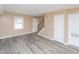 Bright living room features neutral walls, hardwood floors, a window, and staircase to the upper level at 4816 Blue Bird Ct # B, Raleigh, NC 27606