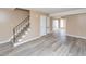 Spacious living room featuring neutral paint, hardwood floors, a staircase, and access to a sunroom at 4816 Blue Bird Ct # B, Raleigh, NC 27606