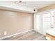 Bright living room with light wood flooring and glass patio doors at 4816 Blue Bird Ct # B, Raleigh, NC 27606