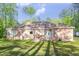 Spacious backyard with a wooden deck and tree lined boundary at 490 Shawnee Dr, Louisburg, NC 27549