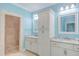 Bathroom with dual sinks, granite counters, tile shower, and vanity at 490 Shawnee Dr, Louisburg, NC 27549