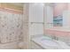 Well-lit bathroom featuring a granite vanity, framed mirror, and floral shower curtain at 490 Shawnee Dr, Louisburg, NC 27549