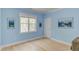 Bright bedroom with light blue walls, light-colored hardwood floors, and a large window at 490 Shawnee Dr, Louisburg, NC 27549