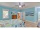 Bedroom with bright blue walls, two windows, and wooden furniture at 490 Shawnee Dr, Louisburg, NC 27549