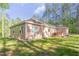 Lovely home boasts a wooden deck, siding, and an expansive green lawn shaded by mature trees at 490 Shawnee Dr, Louisburg, NC 27549