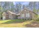 Charming stone-clad home with a well-maintained lawn and appealing architectural details at 490 Shawnee Dr, Louisburg, NC 27549