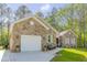 Stone home with a two car garage and a beautiful landscape design at 490 Shawnee Dr, Louisburg, NC 27549