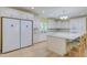 The eat-in kitchen with stainless steel appliances, island with seating, and double door refrigerator at 490 Shawnee Dr, Louisburg, NC 27549