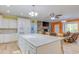 Open layout eat-in kitchen boasts stainless steel appliances, center island, and granite countertops at 490 Shawnee Dr, Louisburg, NC 27549