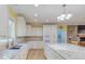 Eat-in kitchen featuring an island with granite countertops, stainless steel appliances, and sink with natural lighting at 490 Shawnee Dr, Louisburg, NC 27549