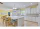 Bright, eat-in kitchen with center island, stone countertops, white cabinets, and stainless steel appliances at 490 Shawnee Dr, Louisburg, NC 27549