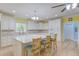 Bright eat-in kitchen features stone countertops, island with seating, and stainless steel appliances at 490 Shawnee Dr, Louisburg, NC 27549