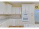 The kitchen features granite countertops, stainless steel appliances, and white cabinetry with chrome hardware at 490 Shawnee Dr, Louisburg, NC 27549
