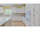 This kitchen features a window over the sink, granite countertops, and double wall ovens at 490 Shawnee Dr, Louisburg, NC 27549
