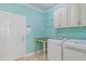 Bright laundry room with white cabinets and modern washer and dryer units at 490 Shawnee Dr, Louisburg, NC 27549