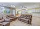 Open floor plan living room boasts leather furniture, open access to kitchen and dining area, and stone accent wall at 490 Shawnee Dr, Louisburg, NC 27549