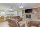 Inviting living room featuring a stone fireplace, hardwood floors, and open kitchen access at 490 Shawnee Dr, Louisburg, NC 27549