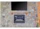 Living room fireplace with stone surround, wood mantle, and flatscreen TV is an eye-catching feature at 490 Shawnee Dr, Louisburg, NC 27549