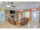 Open-concept living area with stone fireplace, comfortable seating, and modern ceiling fan at 490 Shawnee Dr, Louisburg, NC 27549