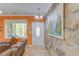 Cozy living area with stone accent wall and view of the outdoors at 490 Shawnee Dr, Louisburg, NC 27549