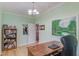 Home office features a bookcase, a view to an adjoining room, and hardwood floors at 490 Shawnee Dr, Louisburg, NC 27549