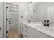 Bathroom featuring double sink vanity with white cabinets, framed mirror, and shower-tub combo at 50 Gadwall Ct, Zebulon, NC 27597