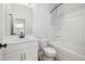 Bathroom with white vanity, toilet, framed mirror, and shower-tub combo at 50 Gadwall Ct, Zebulon, NC 27597