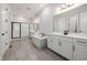 Modern bathroom featuring a soaking tub, double vanity, and walk-in shower at 50 Gadwall Ct, Zebulon, NC 27597