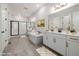 Modern bathroom featuring a soaking tub, glass-enclosed shower, and double vanity with ample counter space at 50 Gadwall Ct, Zebulon, NC 27597