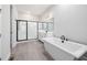 Elegant bathroom with a soaking tub, a glass-enclosed shower, and modern vanity at 50 Gadwall Ct, Zebulon, NC 27597