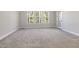 Comfortable bedroom with plush carpet, large windows, and plenty of natural light at 50 Gadwall Ct, Zebulon, NC 27597