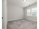 The bedroom has neutral walls, carpeted floors, and window offering plenty of natural light at 50 Gadwall Ct, Zebulon, NC 27597