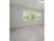 Bright bedroom featuring a large window with scenic views at 50 Gadwall Ct, Zebulon, NC 27597