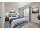 Stylish bedroom with a tufted headboard, blue accents, and a patterned rug for added warmth and character at 50 Gadwall Ct, Zebulon, NC 27597