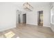 Open dining area with wood floors and an elegant chandelier at 50 Gadwall Ct, Zebulon, NC 27597
