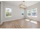 Bright dining area features natural light, wood floors, and a modern chandelier at 50 Gadwall Ct, Zebulon, NC 27597