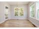 Bright dining area features natural light, wood floors, and a modern chandelier at 50 Gadwall Ct, Zebulon, NC 27597