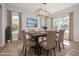Formal dining room with a wooden table, seating for six, and natural light from large windows at 50 Gadwall Ct, Zebulon, NC 27597