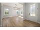 Sunlit dining room with wood floors and modern light fixture at 50 Gadwall Ct, Zebulon, NC 27597