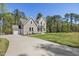 Elegant home with a large driveway, attached garage, and beautifully landscaped front yard at 50 Gadwall Ct, Zebulon, NC 27597