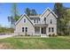 Charming two-story home boasts a welcoming front porch and well-manicured lawn at 50 Gadwall Ct, Zebulon, NC 27597