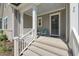 A cozy, covered front porch with charming decor and curb appeal at 50 Gadwall Ct, Zebulon, NC 27597