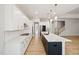 Open concept kitchen featuring an island, stainless steel appliances, and staircase view at 50 Gadwall Ct, Zebulon, NC 27597
