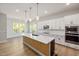Bright kitchen with pendant lights, stainless appliances, island and eat in breakfast nook at 50 Gadwall Ct, Zebulon, NC 27597