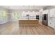 Spacious kitchen with white cabinets, wood island, stainless appliances, and modern pendant lighting at 50 Gadwall Ct, Zebulon, NC 27597