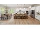Bright, open kitchen featuring white cabinetry, stainless steel appliances, and a large island with a seating area at 50 Gadwall Ct, Zebulon, NC 27597