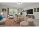 Cozy living room with comfortable seating, natural light, and a decorative rug over hardwood flooring at 50 Gadwall Ct, Zebulon, NC 27597