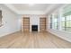 Bright living room boasts wood floors, a fireplace with built-in shelves and a large sunroom at 50 Gadwall Ct, Zebulon, NC 27597